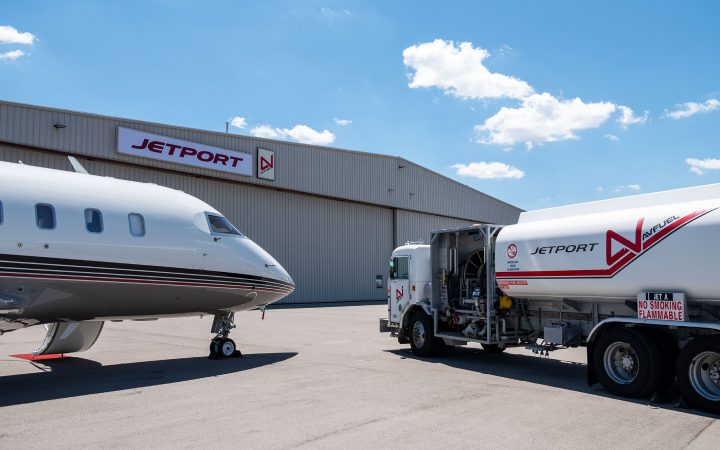 Truck and private jet outside Jetport hanger.